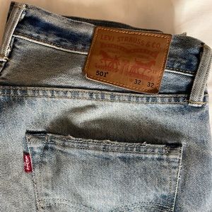 Light blue color naturally ripped classic 501 Levis